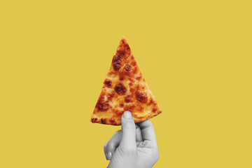 Hand holding slice of Classic cheese pizza, on yellow background