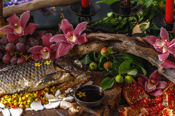 Still life in old masters style with fish, glass of wine, old dishes, fruits. The concept of a richly decorated table.
