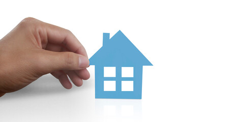 Hands holding paper house, family home  protecting insurance concept