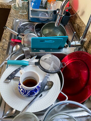 A lot of dirty dishes in the Sink waiting for been dishwash