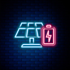Glowing neon line Solar energy panel and battery icon isolated on brick wall background. Colorful outline concept. Vector