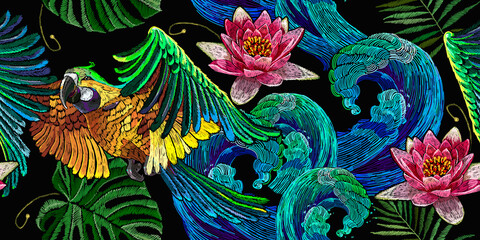 Colorful flying ara parrots, palm leaves, sea waves and pink lotus flowers seamless pattern. Macaws. Fashionable template for design of clothes, textiles. Magic romantic tropical background © Matrioshka