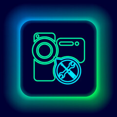 Glowing neon line Video camera with screwdriver and wrench icon isolated on black background. Adjusting, service, setting, maintenance, repair, fixing. Colorful outline concept. Vector