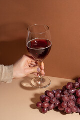 Glass of red wine on the background, with grapes