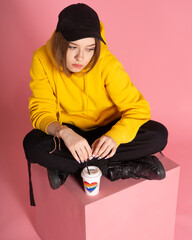 Woman with LGBT rainbow coffee cup