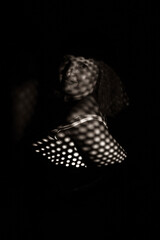 black and white portrait of an overweight woman. Art photography with unusual shadows