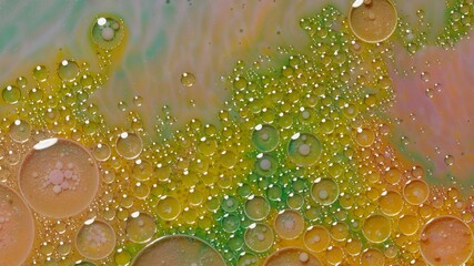 Colorful, gorgeous, vibrant theme or background, cosmetic effect. Bubbles float in liquid paint. Mixing ink, oil and milk. Abstract multicolor hypnotic painting. Macro. Pattern, design