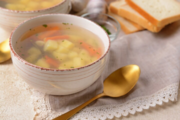 Bowl with tasty garlic soup on light background