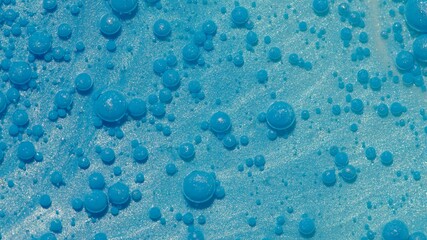 Top view fantastic structure of colorful oil paint and ink bubbles. Chaotic motion. Abstract blue paint. Movement in liquid. Water surface multicolored texture background. Macro. Pattern, design