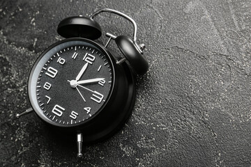 Alarm clock on dark background, closeup