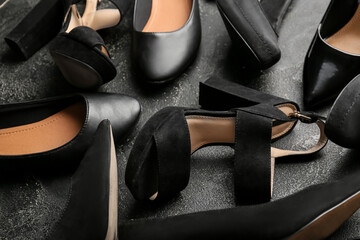 Various female stylish shoes on dark background