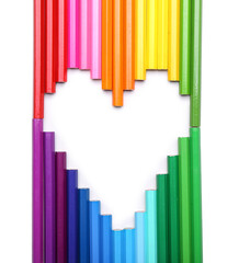 Heart shape made of colorful pencils on white background