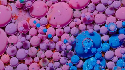 Macro structure of multicolored water paint oil bubbles. Bright colorful acrylic painting. Fantastic surface with chaotic motion liquid. Top view. Mobile phone screen style, theme wallpaper background