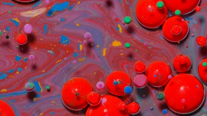 Top view fantastic structure of colorful oil paint and ink bubbles. Chaotic motion. Abstract colorful paint. Movement in liquid. Water surface multicolored texture background. Macro. Pattern, design