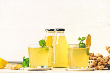Composition with healthy ginger juice on light background