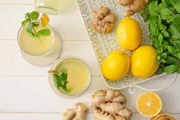 Composition with healthy ginger juice on white wooden background