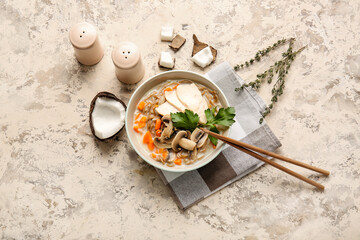 Bowl with Thai chicken noodle soup on grunge background