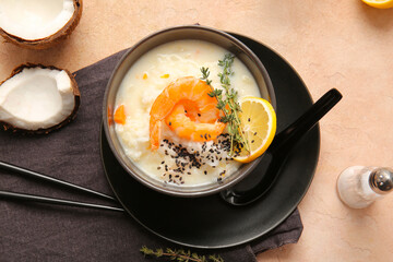 Bowl with Thai rice soup on color background