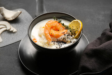 Bowl with Thai rice soup on dark background