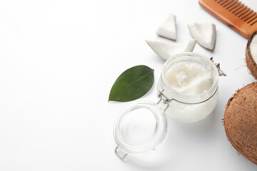 Jar with coconut oil on white background