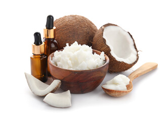 Bottles, bowl and spoon with coconut oil on white background