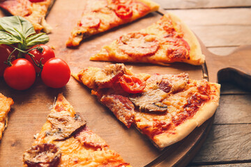 Board with tasty pizza on wooden background, closeup