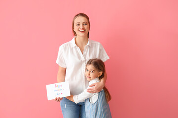 Little girl and her mom with greeting card for Mother's Day against color background