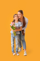 Little girl and her mom with bouquet of flowers on color background