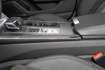 Black luxury modern car Interior. Steering wheel, shift lever and dashboard. Detail of modern car...