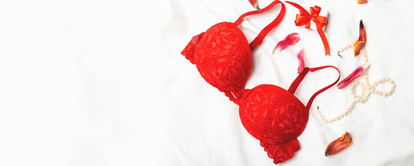Woman elegant red lace bra and jewelry. Stylish lingerie flat lay. copy space