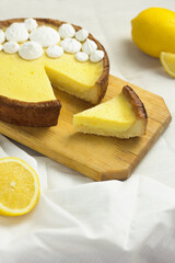 Slice of Lemon Meringue Pie. Traditional French Tart. Homemade dessert. Piece of cake on wooden board.