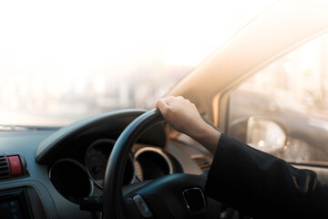 Fototapeta premium Woman hands holding a steering wheel confidently.