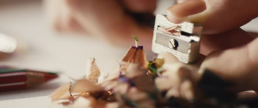 Pencil sharpener in hands female fingers macro close up slow motion
