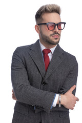 sexy young businessman crossing arms and looking to side