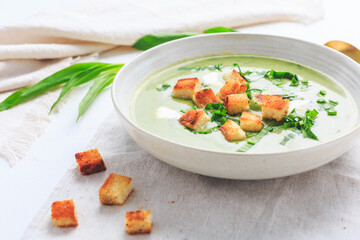 Ramson or bear leek soup with crouton and sour cream