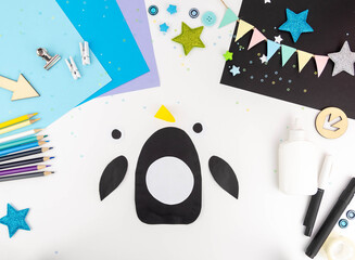 Step-by-step instruction of making a penguin out of paper with children. Step 2