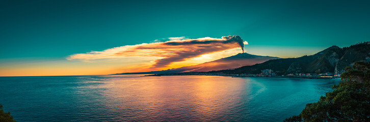 Panoramic view of Mount Etna at sunset by the sea. Last eruption of Mt Etna