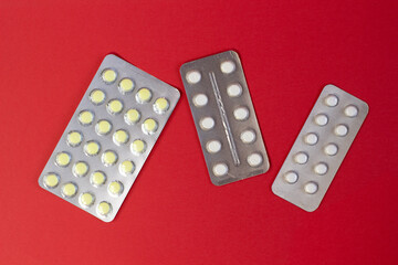 Group of colorful pills as nice bright red textured background Narrow focus line, shallow depth of field