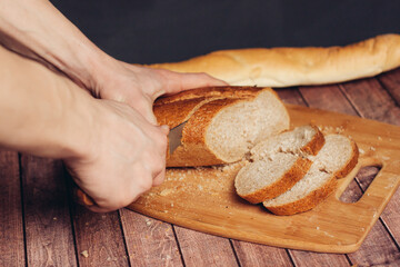 slicing a fresh loaf on a cutting board kitchen meal