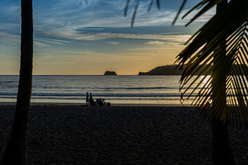 Beautiful view of a magical sunset in Carrillo beach with the silhouette of people enjoying life