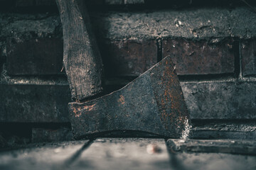 old rusty ax in the barn. steel arms. dangerous tool.