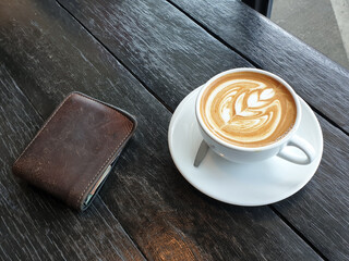 Coffee cup wth wallet showing coffee cost of people addicted coffee