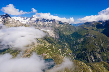 Aerial view of the Grimsel and Furka mountain pass in the alps between cantons of Bern, Valais and Uri in Switzerland on a sunny summer day