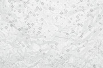 Sheet of crumpled white paper with Chinese ornament and flowers.