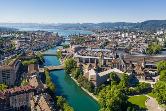 Aerial view of the Limmat river that flow through the Zurich city center by the national museum, the train station and the old town to finish in lake Zurich on a sunny summer day