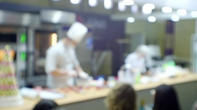 Chefs conduct a master class in front of the assembled audience.