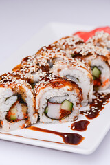 Maki Sushi Rolls made of smoked eel, cream cheese and unagi sauce. Traditional Japanese cuisine concept.
