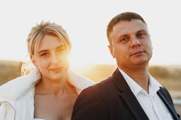 Portrait of a bride and groom in a sunset light