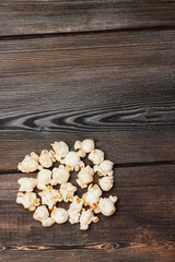 Obraz na płótnie Canvas popcorn on wooden background delicacy classic snack