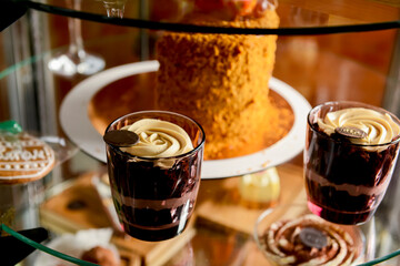 Dessert stand in cafe. Glass stand with different cakes and desserts, sweet food. Eating out concept